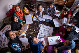 Photo of people making signs. Link to What to Give